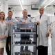 The Planet team at their new factory; from left, Planet director of forest programs Tara O’Shea; Planet co-founders Robbie Schingler and Will Marshall; Minister of Climate and Environment for Norway Ola Elvestuen; Planet vp of manufacturing Chester Gilmore.